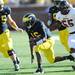 Michigan senior quarterback Denard Robinson looks to break away in the second quarter at Michigan Stadium on Saturday. Melanie Maxwell I AnnArbor.com